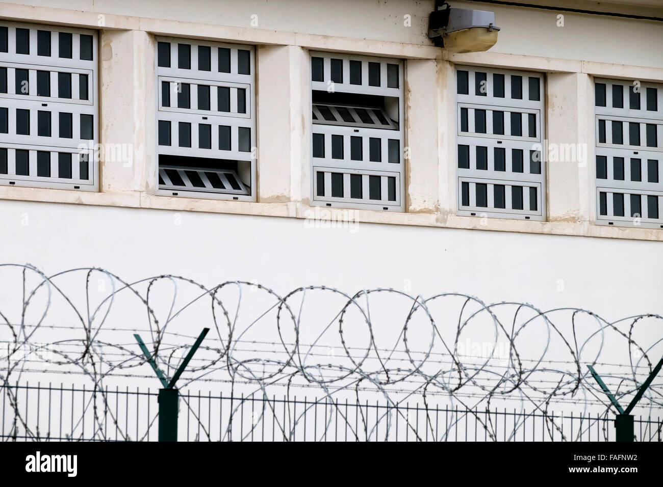Prison walls with barbwire Stock Photo