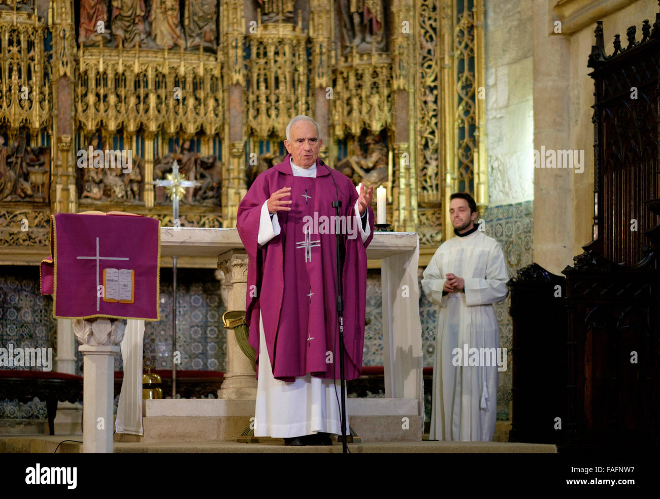 Old priest celebrating catholic mass Stock Photo