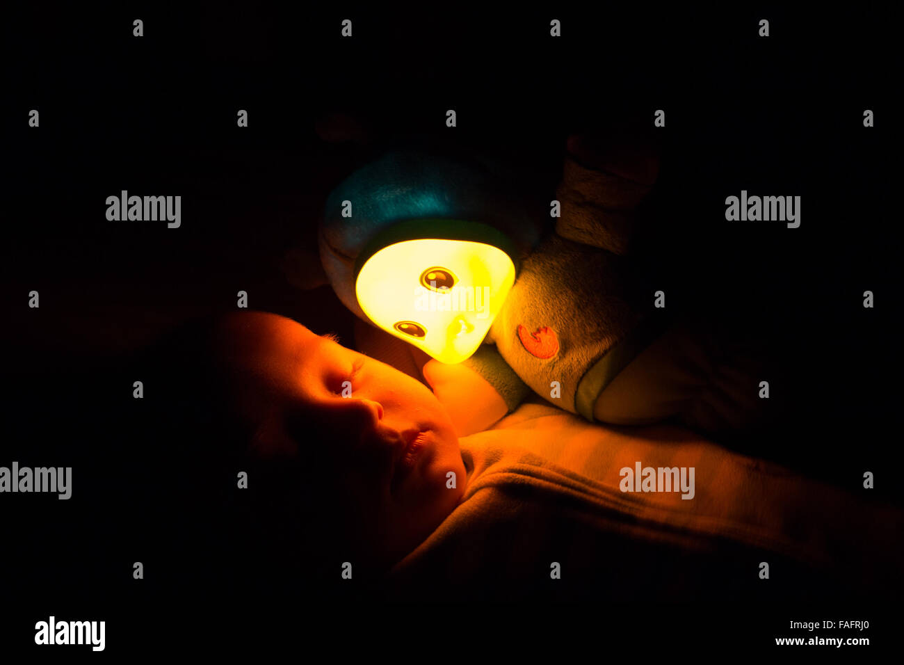 Sleeping Baby With His Glow Worm Stock Photo Alamy