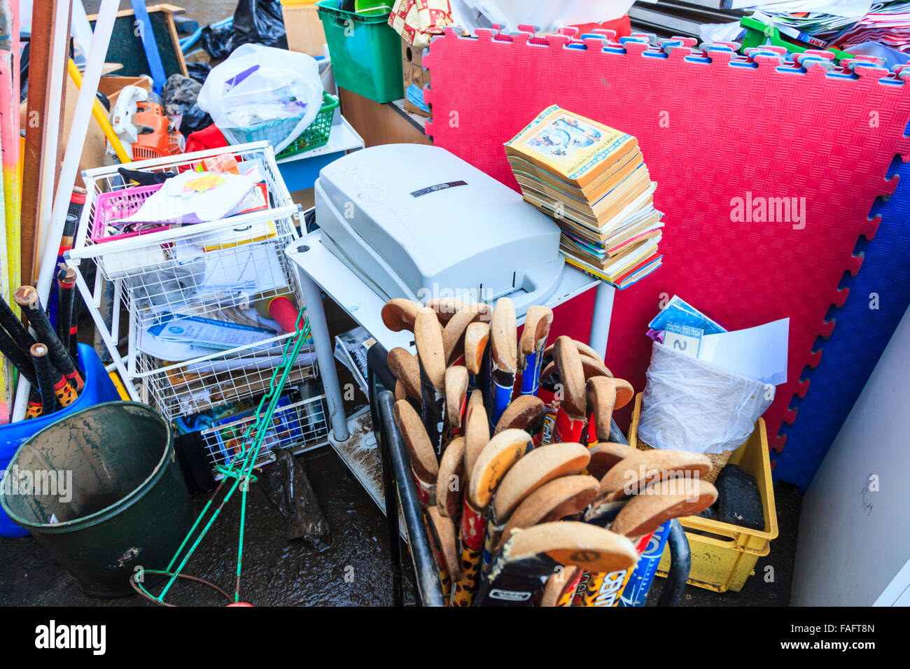 Hebden Bridge, UK. 29th Dec, 2015. School furniture, books and equipment, destroyed in the Hebden Bridge Boxing Day floods, are piled up in the Riverside Junior School playground, while volunteers load it into skips and vans. Credit:  Graham Hardy/Alamy Live News Stock Photo