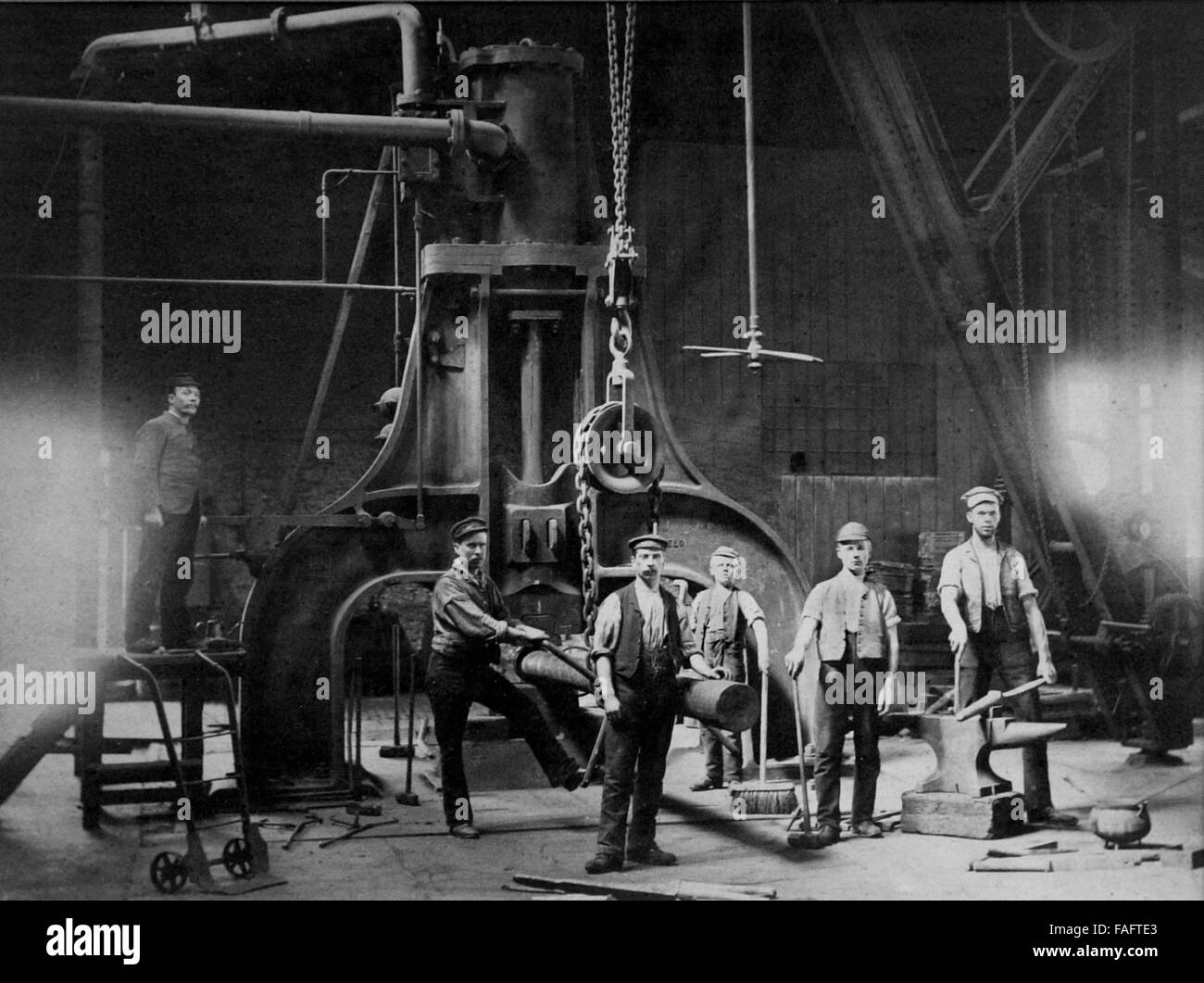 Iron workers operating Steam Hammer at Coalbrookdale Ironworks in 1872 Stock Photo