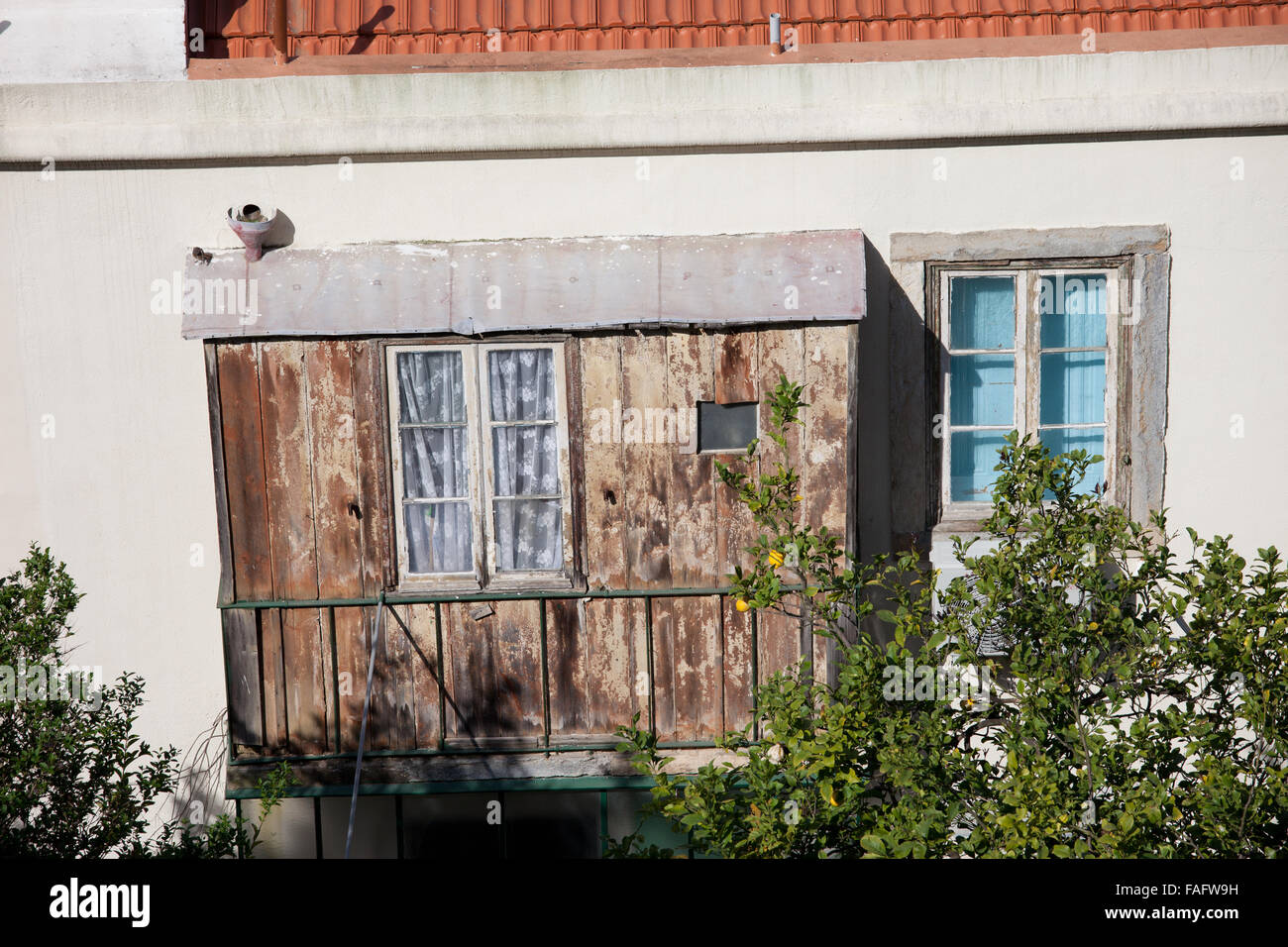 Old house with bay window covered balcony with wood in Lisbon, Portugal Stock Photo