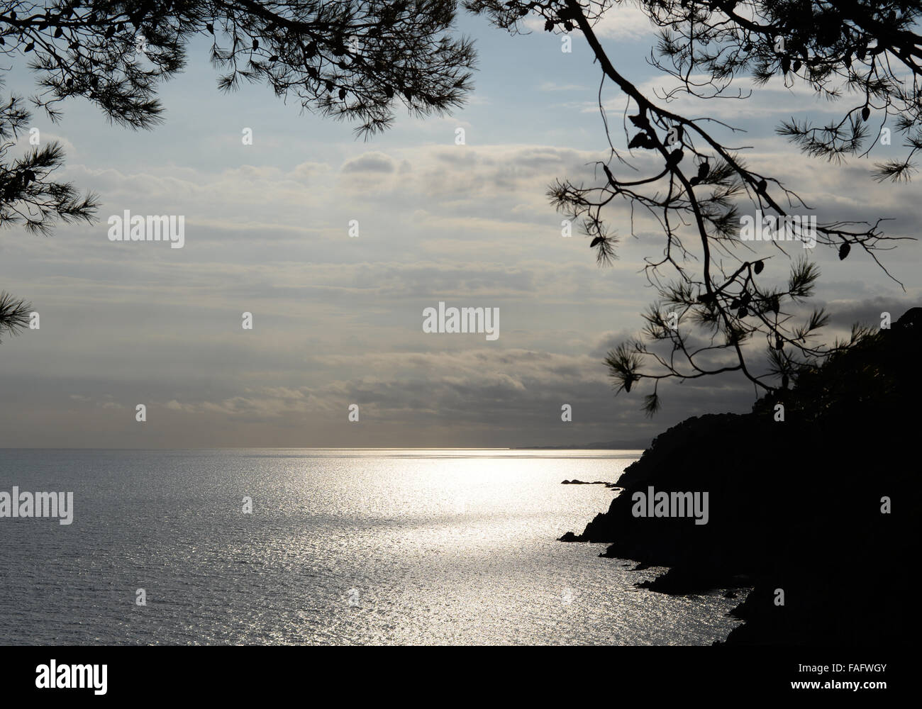 Tossa De Mar beautiful scenic coastal image with sunrays and silhouette. Stock Photo