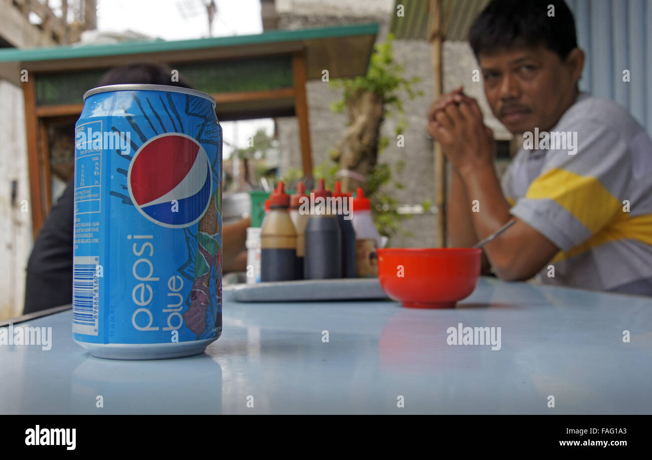 Pepsi Blue can on Indonesian restaurant table Stock Photo