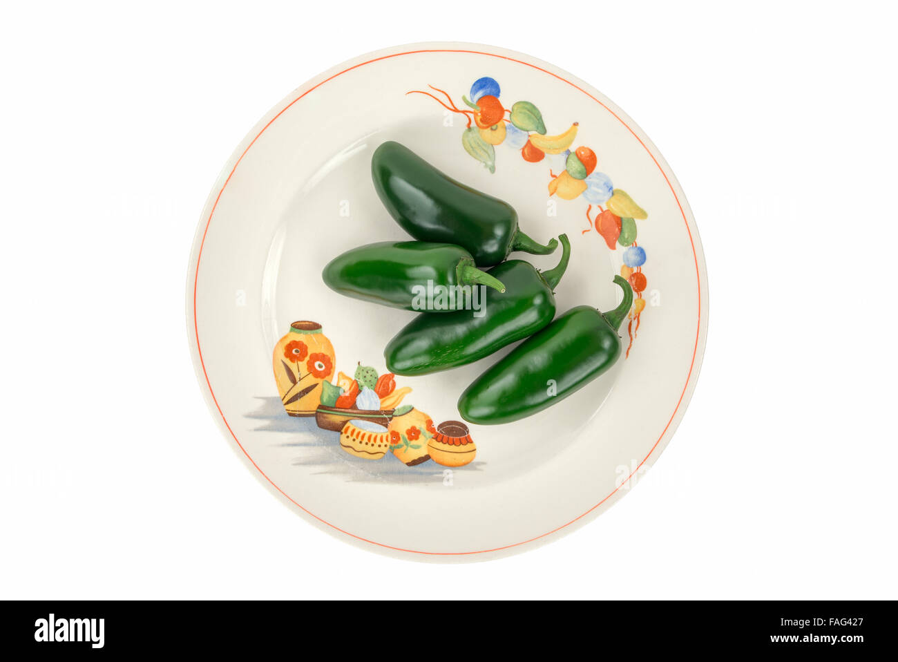 Four Green Jalapeno Peppers on a Colorful, Festive, Antique Fiesta Plate isolated on white. Stock Photo