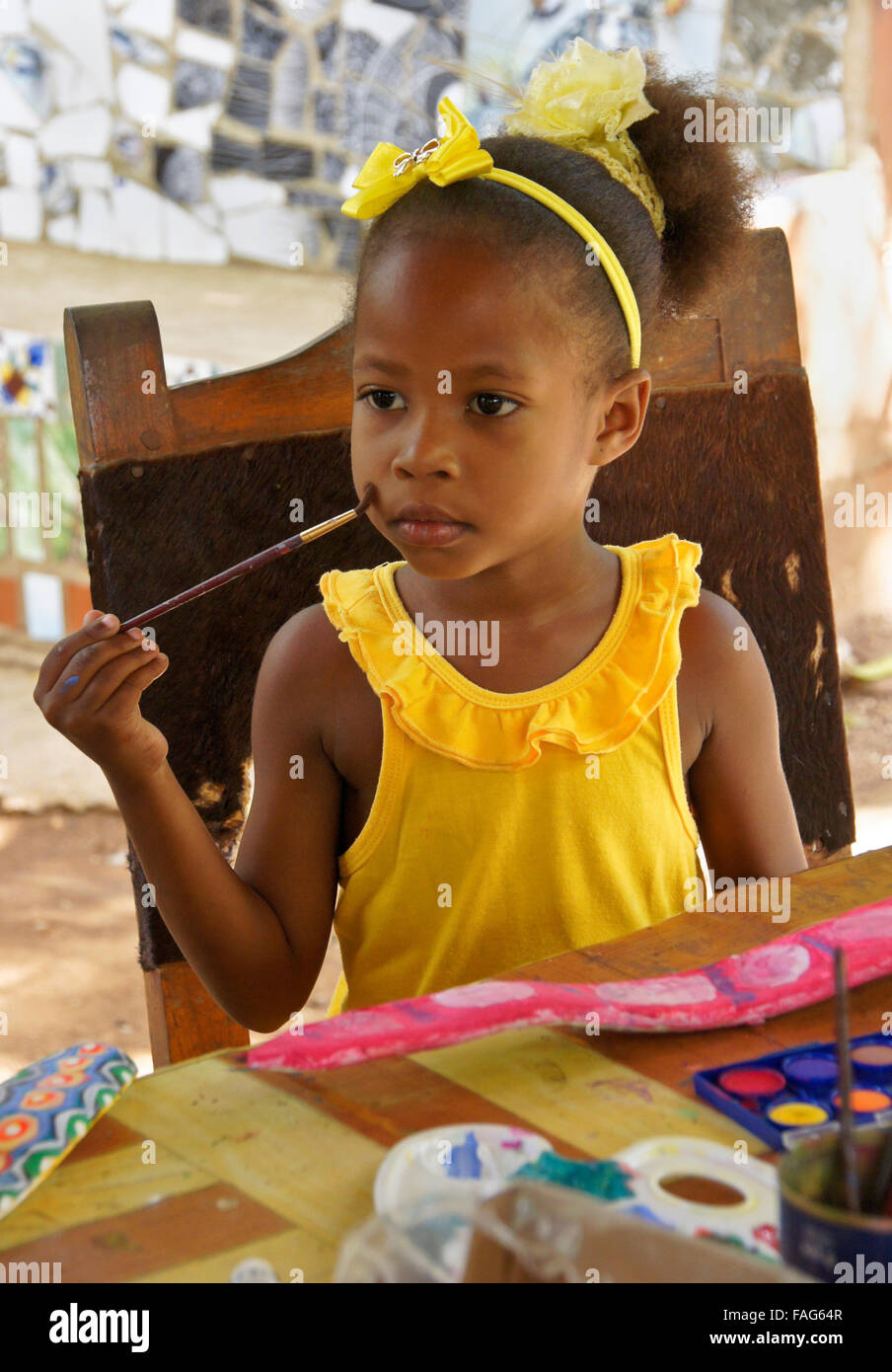 Little girl working on art project (painted seed pod), Pinar del Rio, Cuba Stock Photo