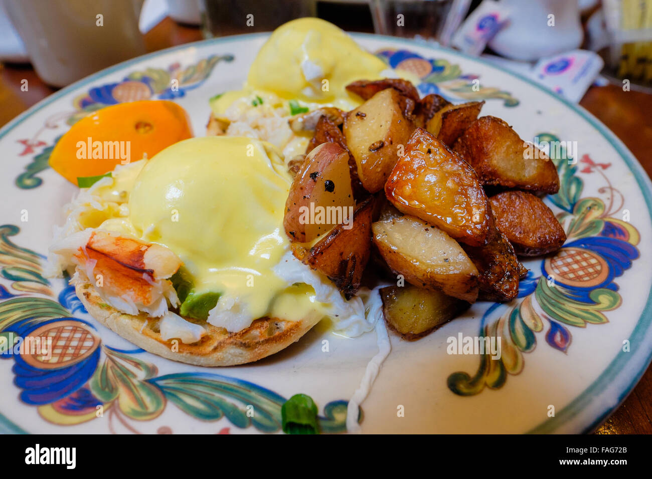 Breakfast plate of crab eggs benedict with home fries Stock Photo Alamy