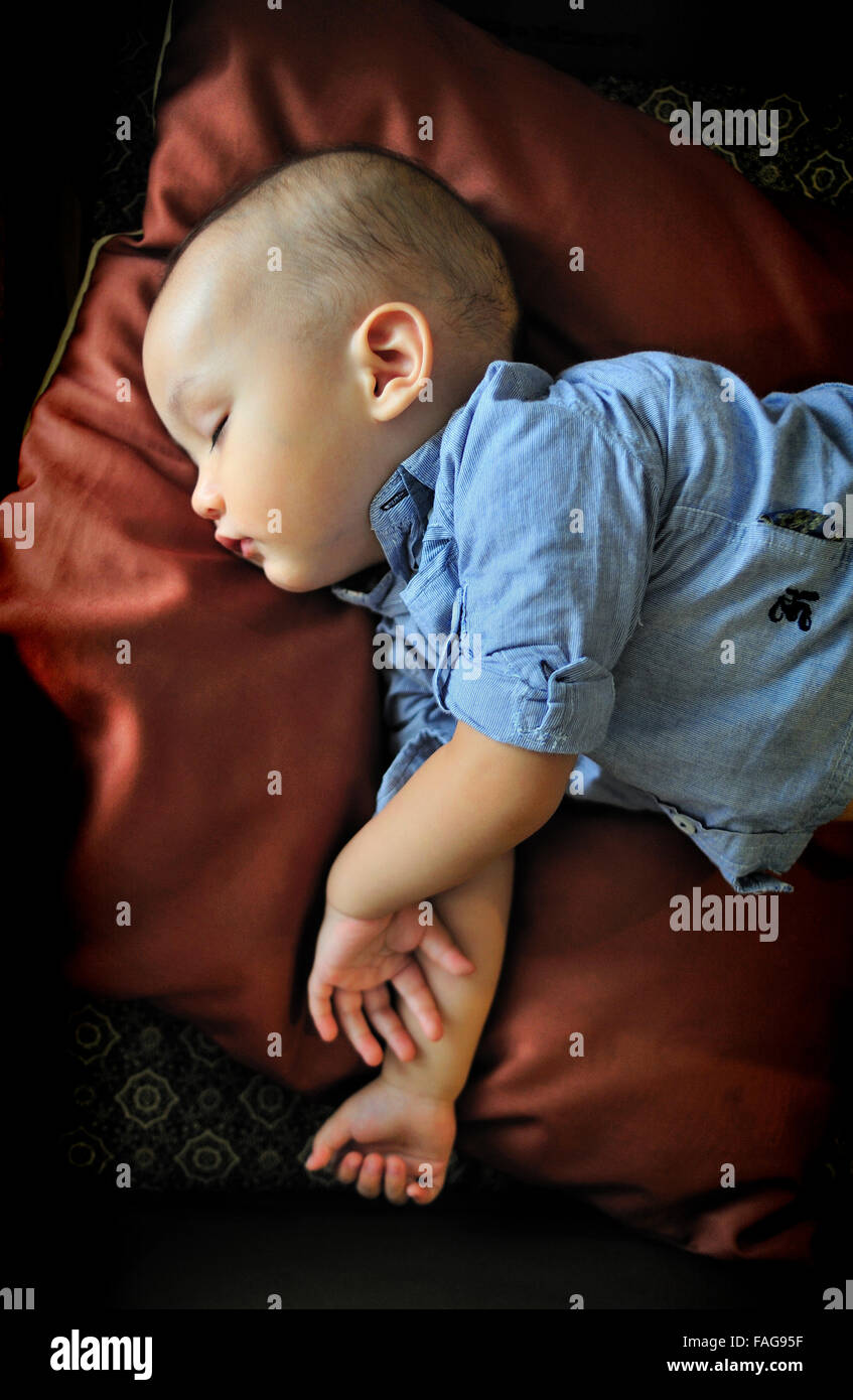 Beautiful baby boy sleeping after feed. Stock Photo