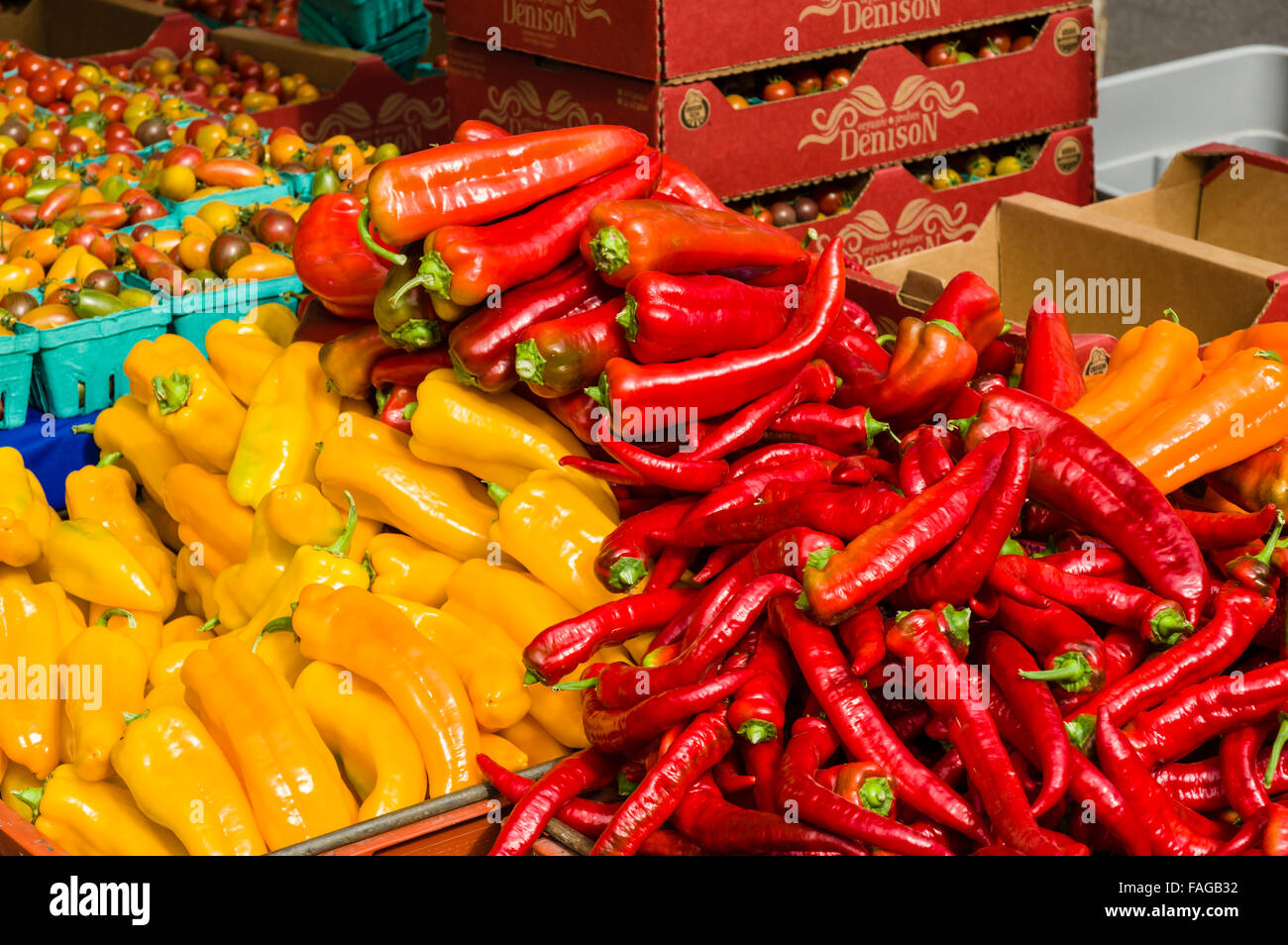 Red and yellow hot peppers in boxes at a farmers market in Beaverton, Oregon, USA Stock Photo