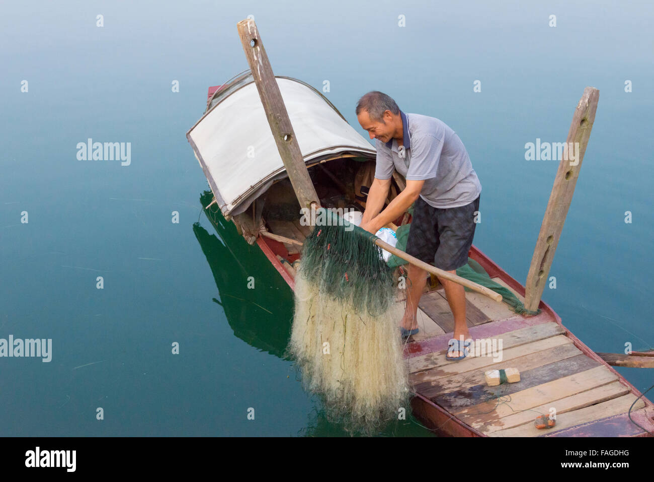 Man on fishing boat, Yongzhou, Hunan Province, China Stock Photo