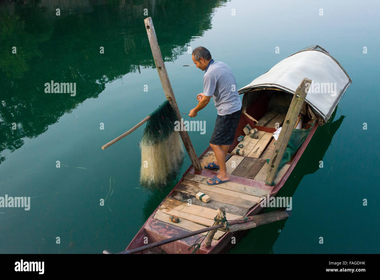 Man on fishing boat, Yongzhou, Hunan Province, China Stock Photo