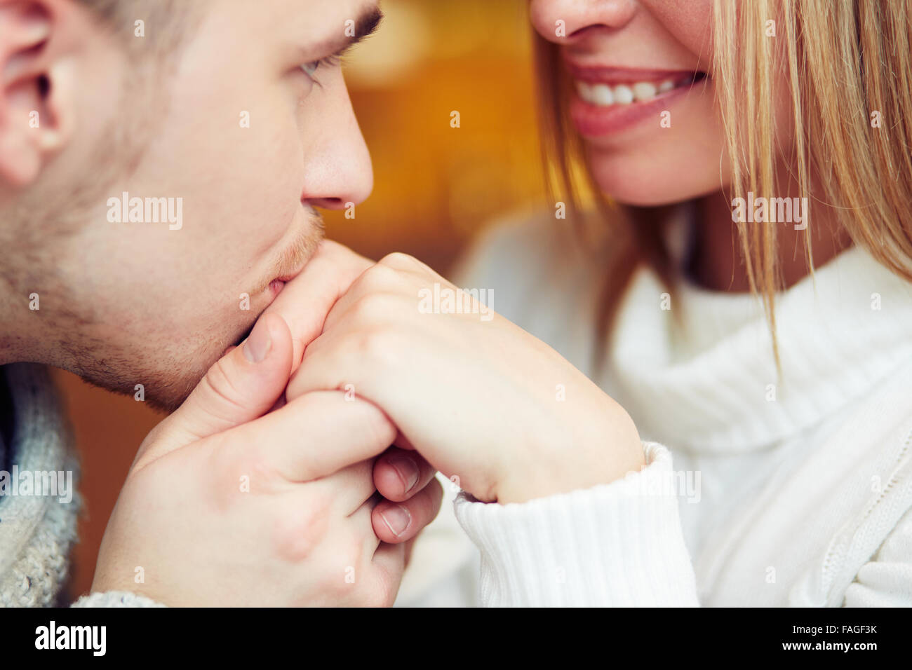 Guy kissing hand of his girlfriend Stock Photo - Alamy