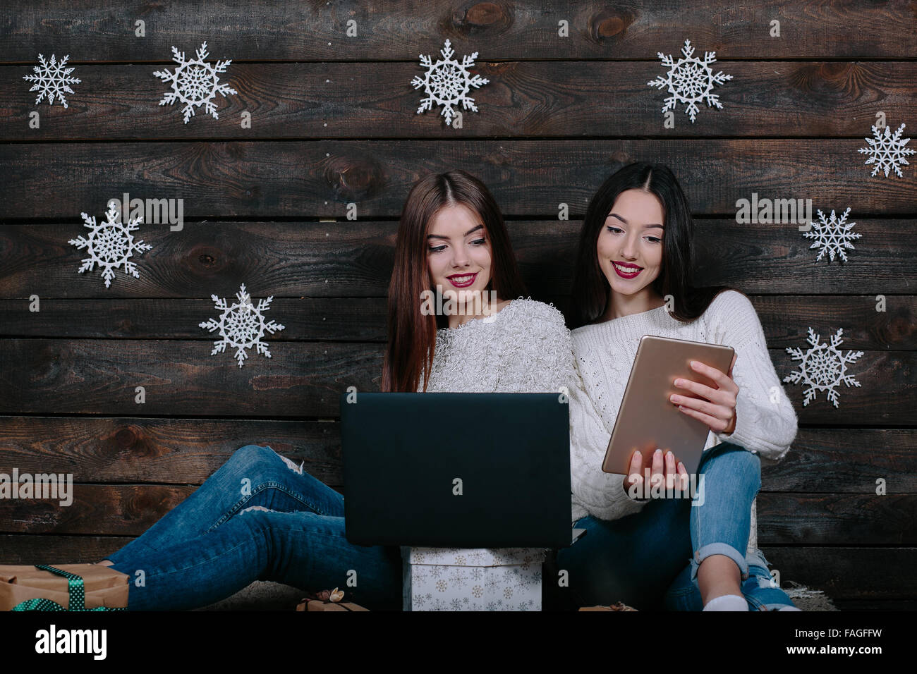 Two beautiful girls siting on the floor Stock Photo - Alamy