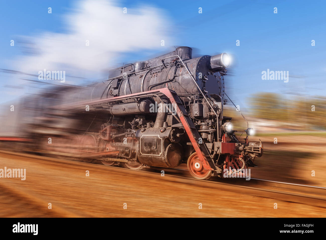 Old retro train with steam moves fast Stock Photo Alamy