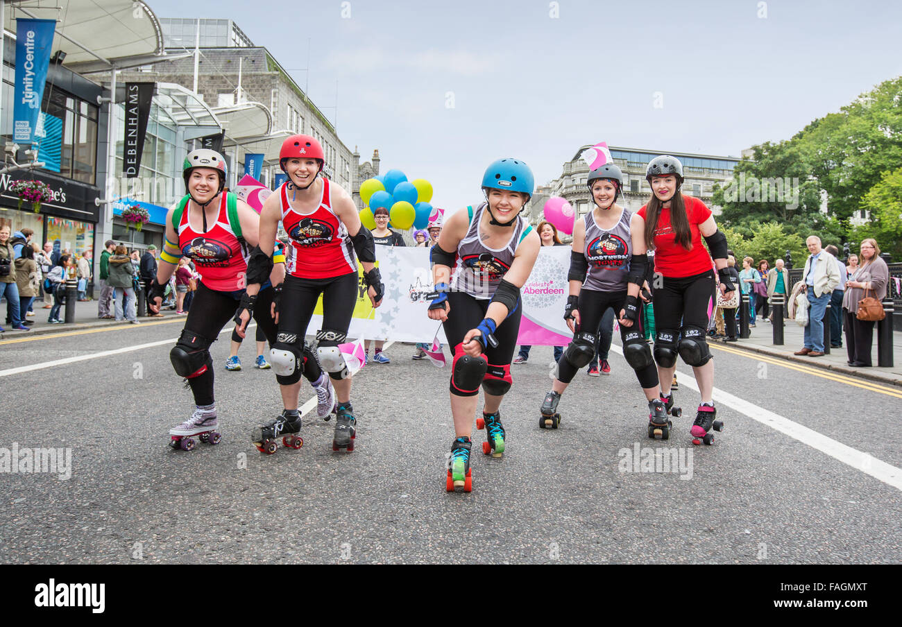 Roller derby girls at the annual Celebrate Aberdeen parade down Union Street in the city of Aberdeen, Scotland, UK Stock Photo