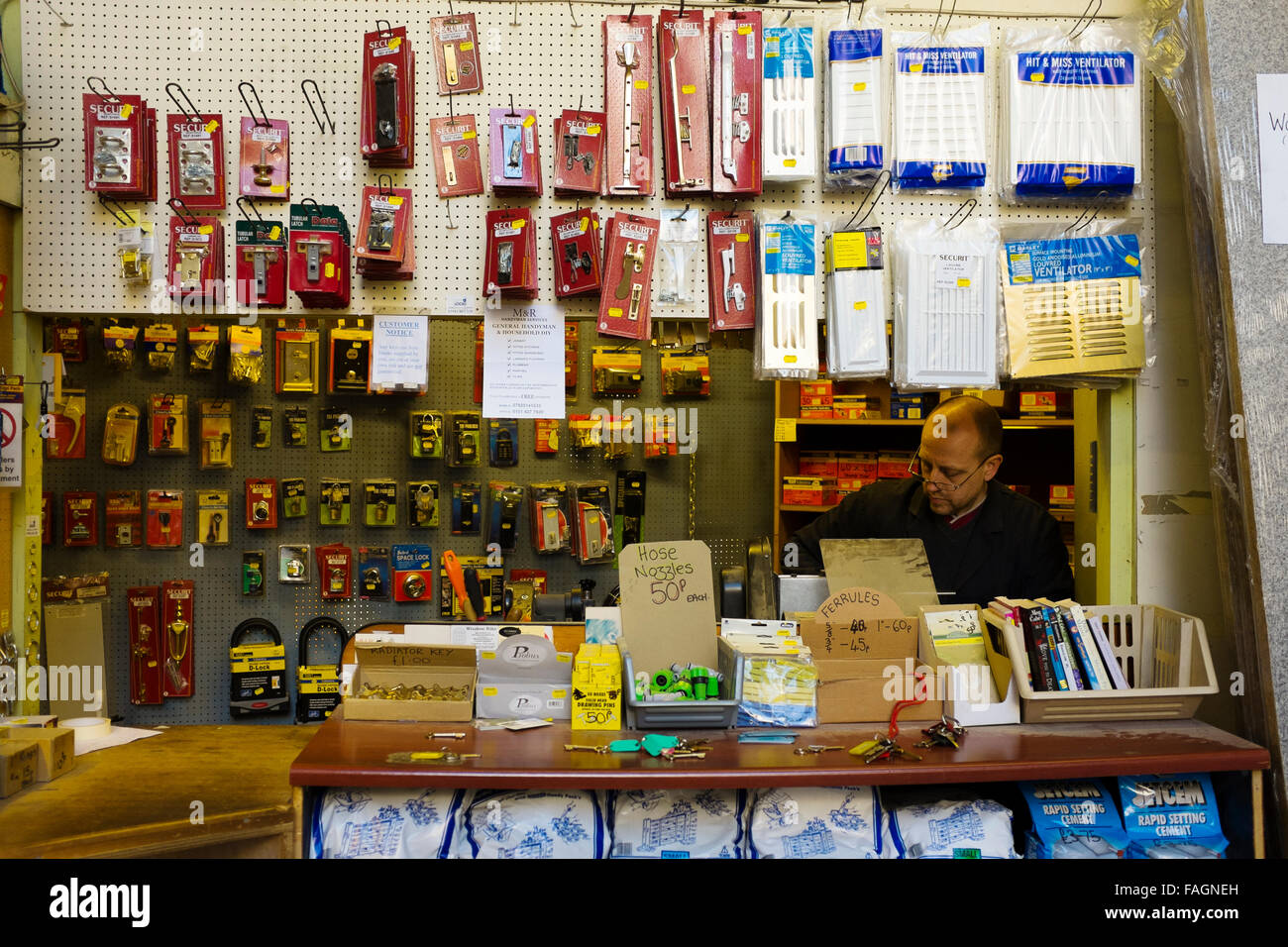 Products for sale hanging from displays in a traditional hardware shop in the suburbs of Liverpool. Such stores are dissapearing Stock Photo