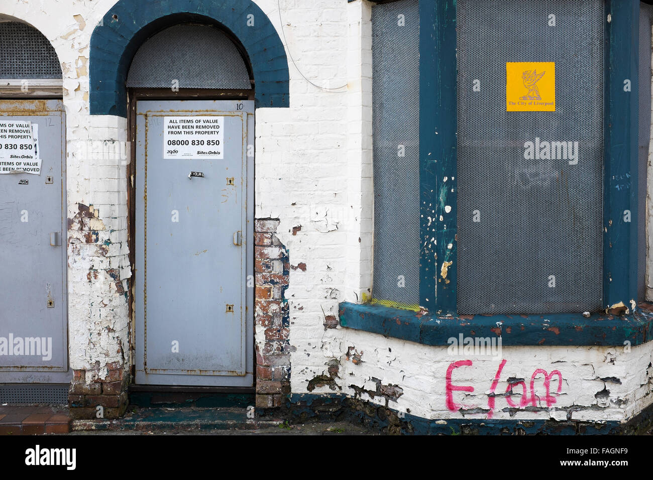 A boarded up house in Liverpool 8 has metal screens on doors and windows to deter vandals and thieves. Liverpool council owns Stock Photo