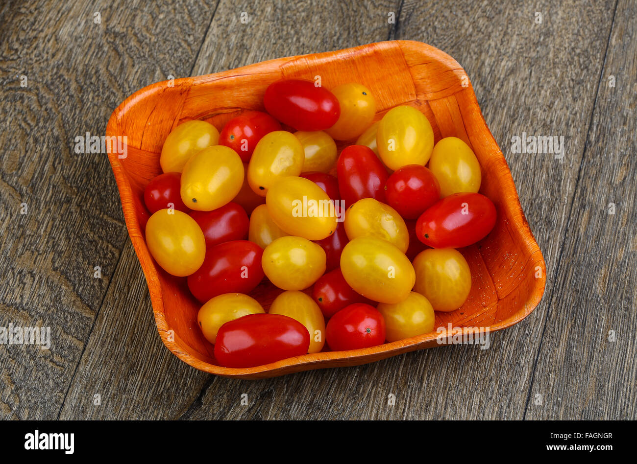 Yellow and red cherry tomatoes mix on the basket Stock Photo - Alamy