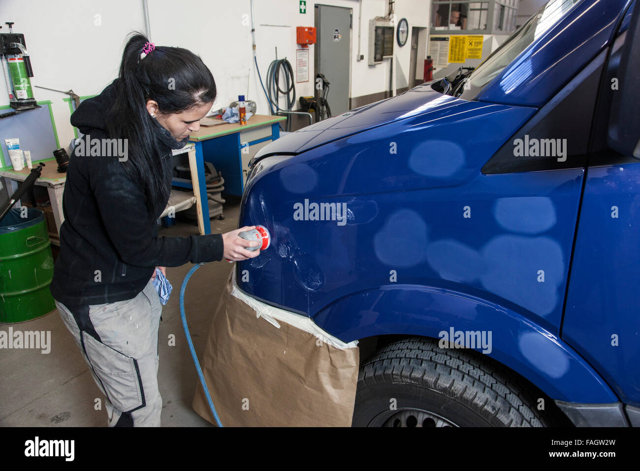 Car-body polishes the varnish of a vehicle. Stock Photo