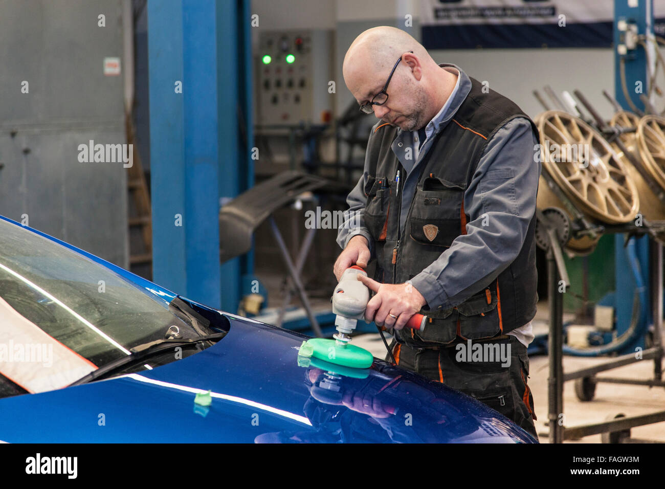 Car-body polishes the varnish of a vehicle. Stock Photo
