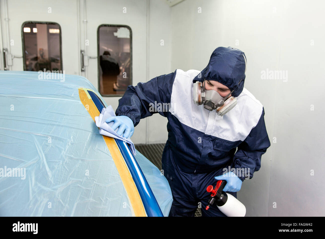 Vehicle varnisher cleans the places to be painted. Stock Photo