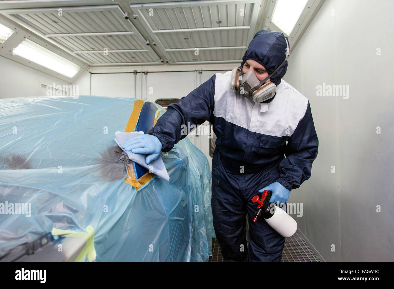 Vehicle varnisher cleans the places to be painted. Stock Photo