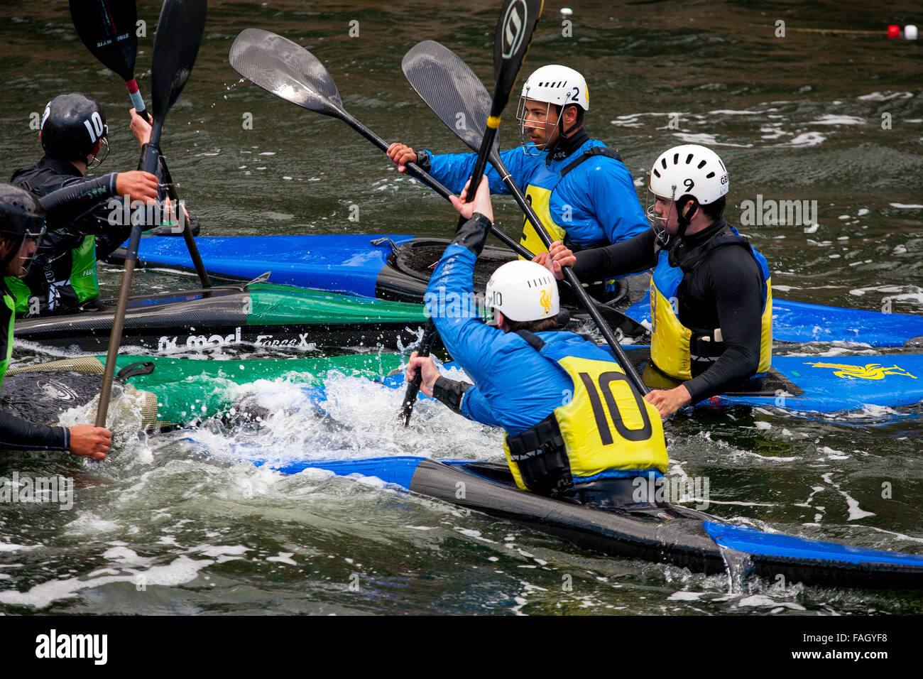 Teams of Kayakers compete at a kayak water polo match in the canals of
