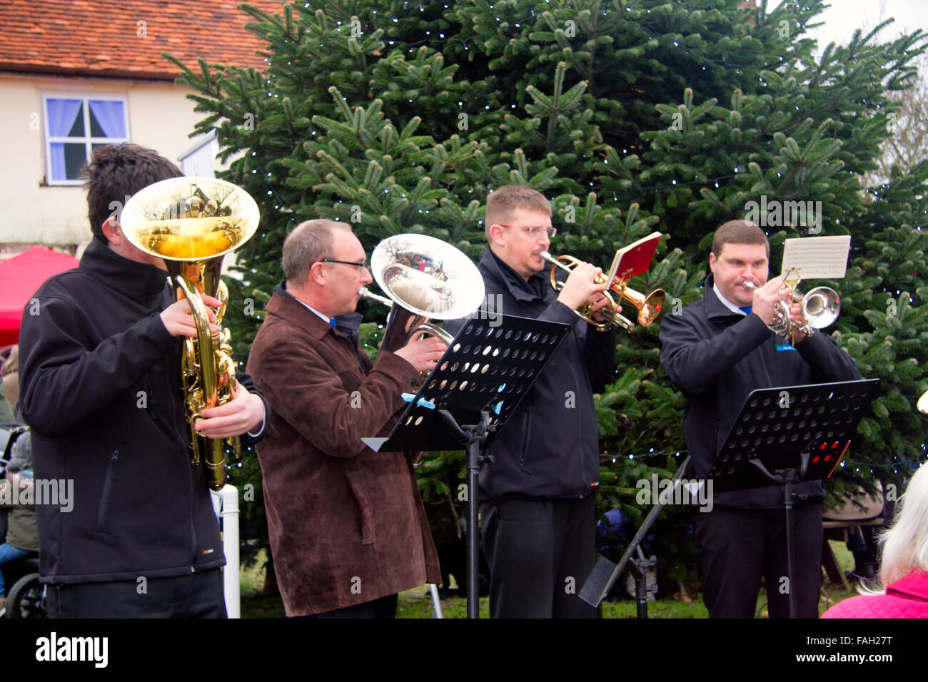 Brass band playing Christmas carols by a Christmas tree, Jimmy's Farm