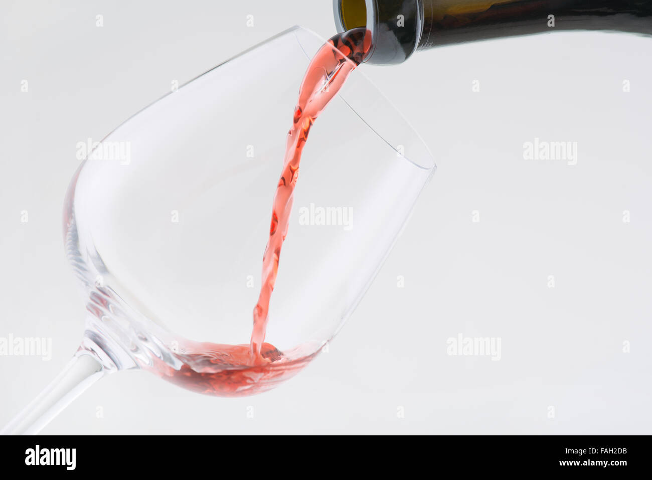 Wine is being poured into the glass. Stock Photo