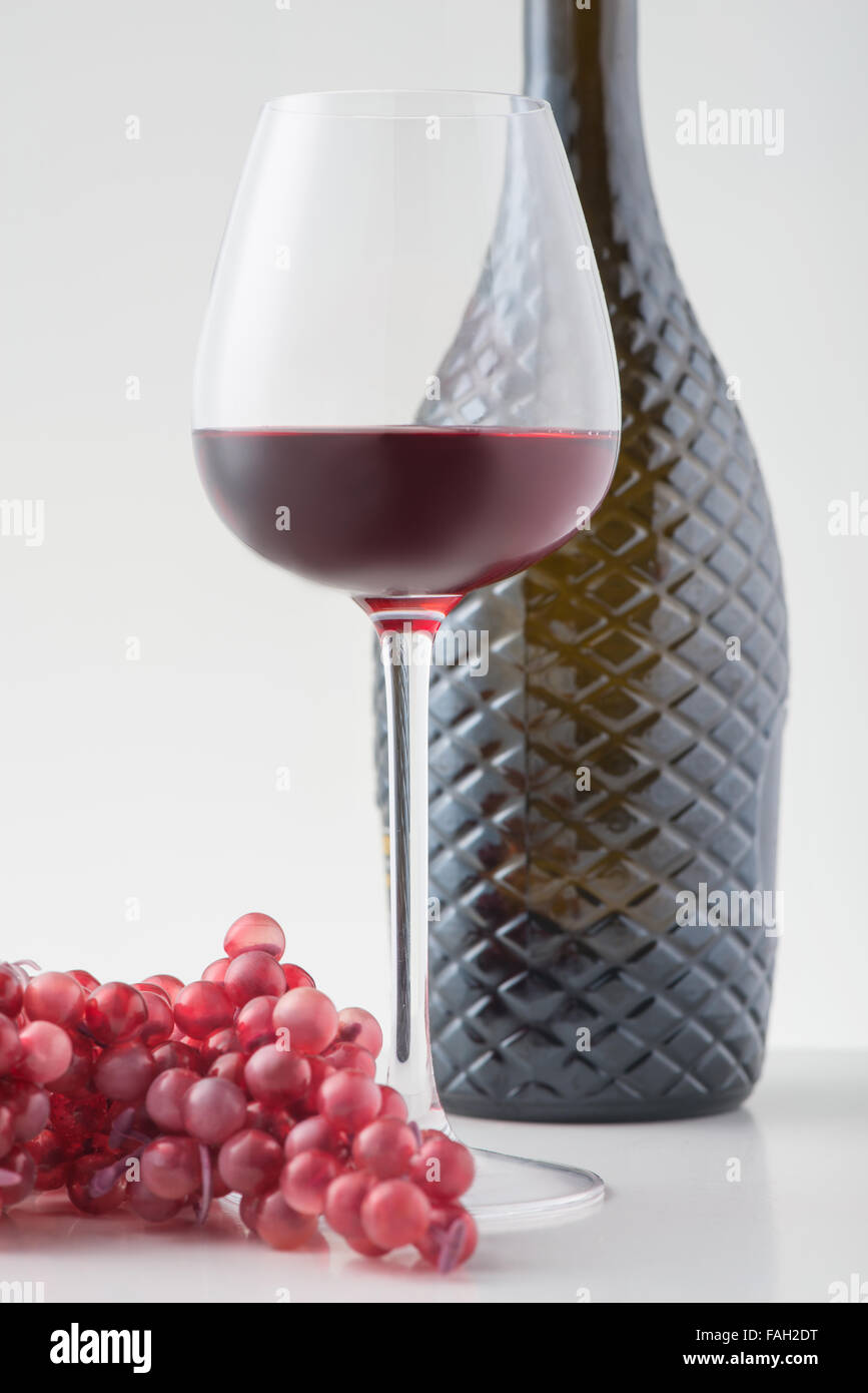 Red wine and sprig of grapes on the surface Stock Photo