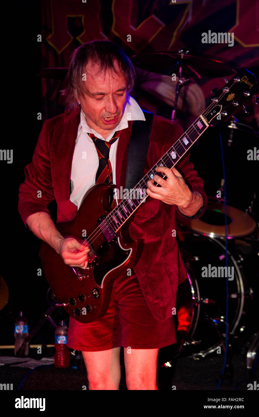 Dundee, Tayside, Scotland, UK, December 29th 2015. AC/DC Tribute rock band “AC/DC UK” play live at the Beat Generator nightclub in Dundee/ Lead guitarist Mike (Angus Young) playing his Gibson S-G Guitar. © Dundee Photographics / Alamy Live News. Stock Photo