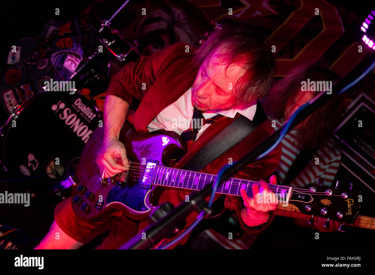 Dundee, Tayside, Scotland, UK, December 29th 2015. AC/DC Tribute rock band “AC/DC UK” play live at the Beat Generator nightclub in Dundee/ Lead guitarist Mike (Angus Young) playing his Gibson S-G Guitar. © Dundee Photographics / Alamy Live News. Stock Photo