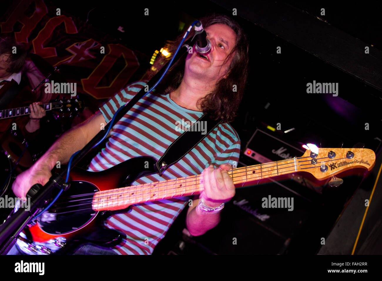 Dundee, Tayside, Scotland, UK, December 29th 2015. AC/DC Tribute rock band “AC/DC UK” play live at the Beat Generator nightclub in Dundee. Bass guitarist Bill Bowden (Cliff Williams) and Drummer Billy Rauff (Phil Rudd). © Dundee Photographics / Alamy Live News. Stock Photo