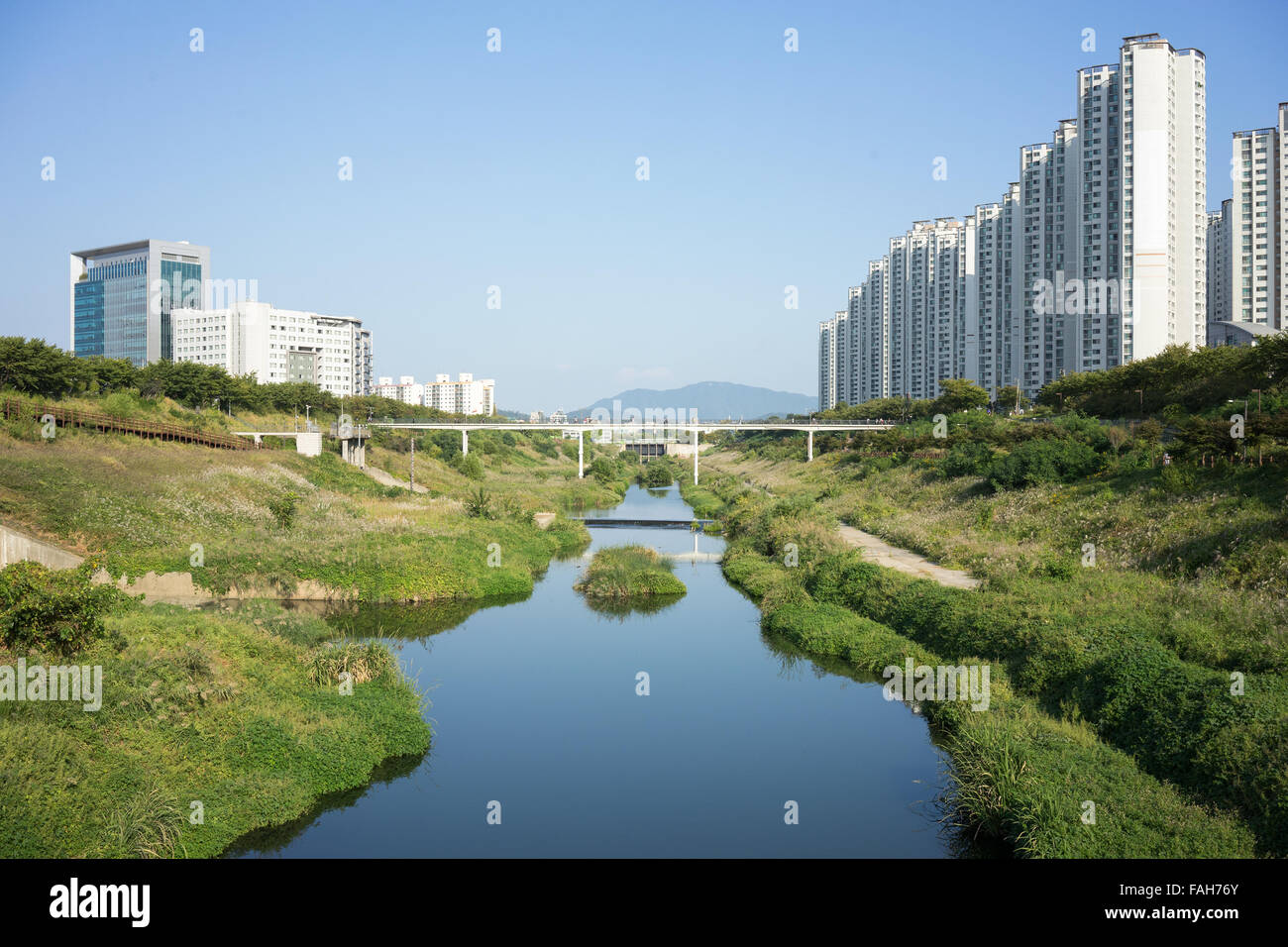 Apartment buildings with stream and and grassland area in a natural