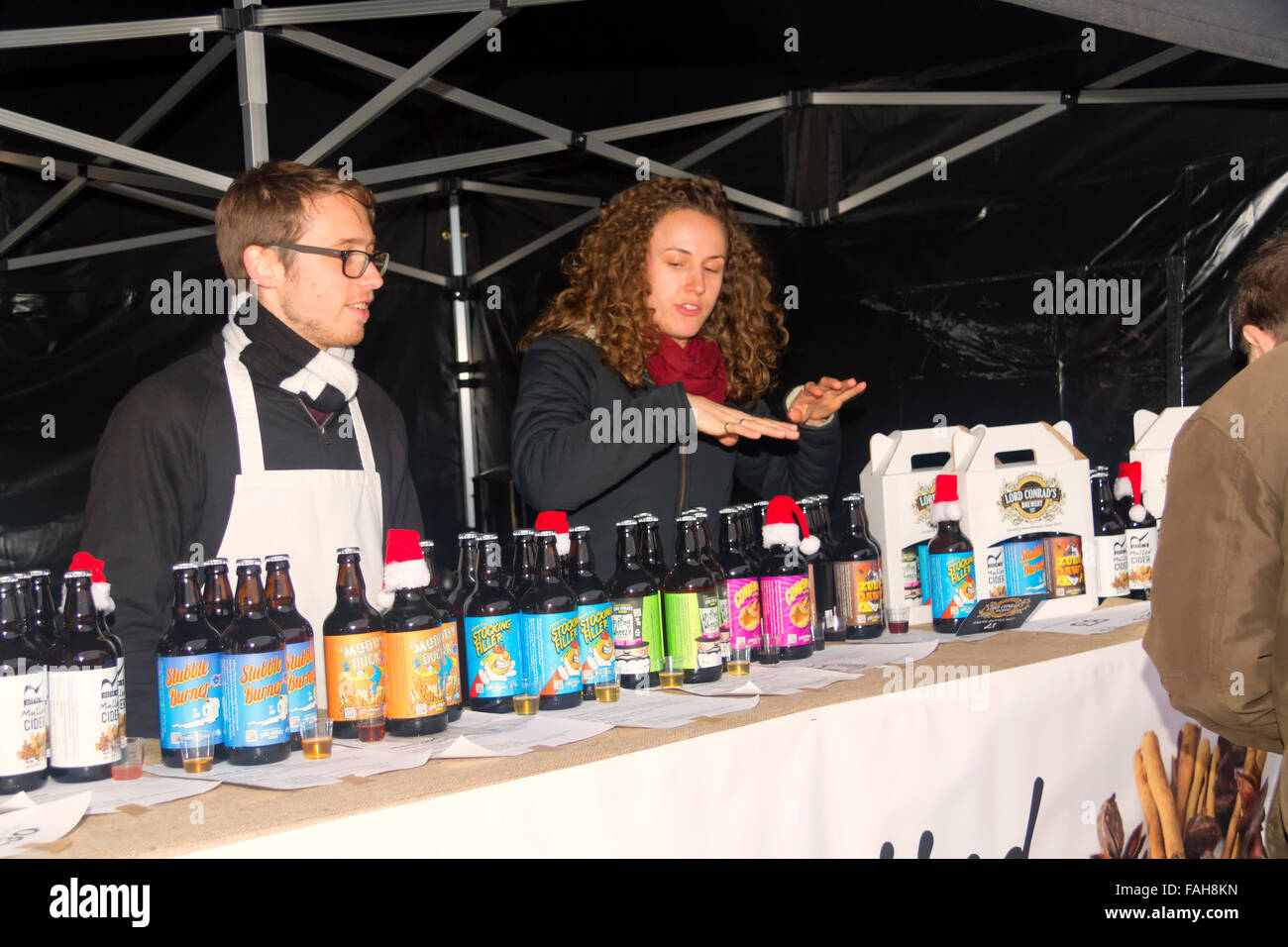 Stallholder selling bottled drinks, Christmas Market, Jimmy's Farm, Wherstead, Ipswich, Suffolk, UK, December 2015 Stock Photo