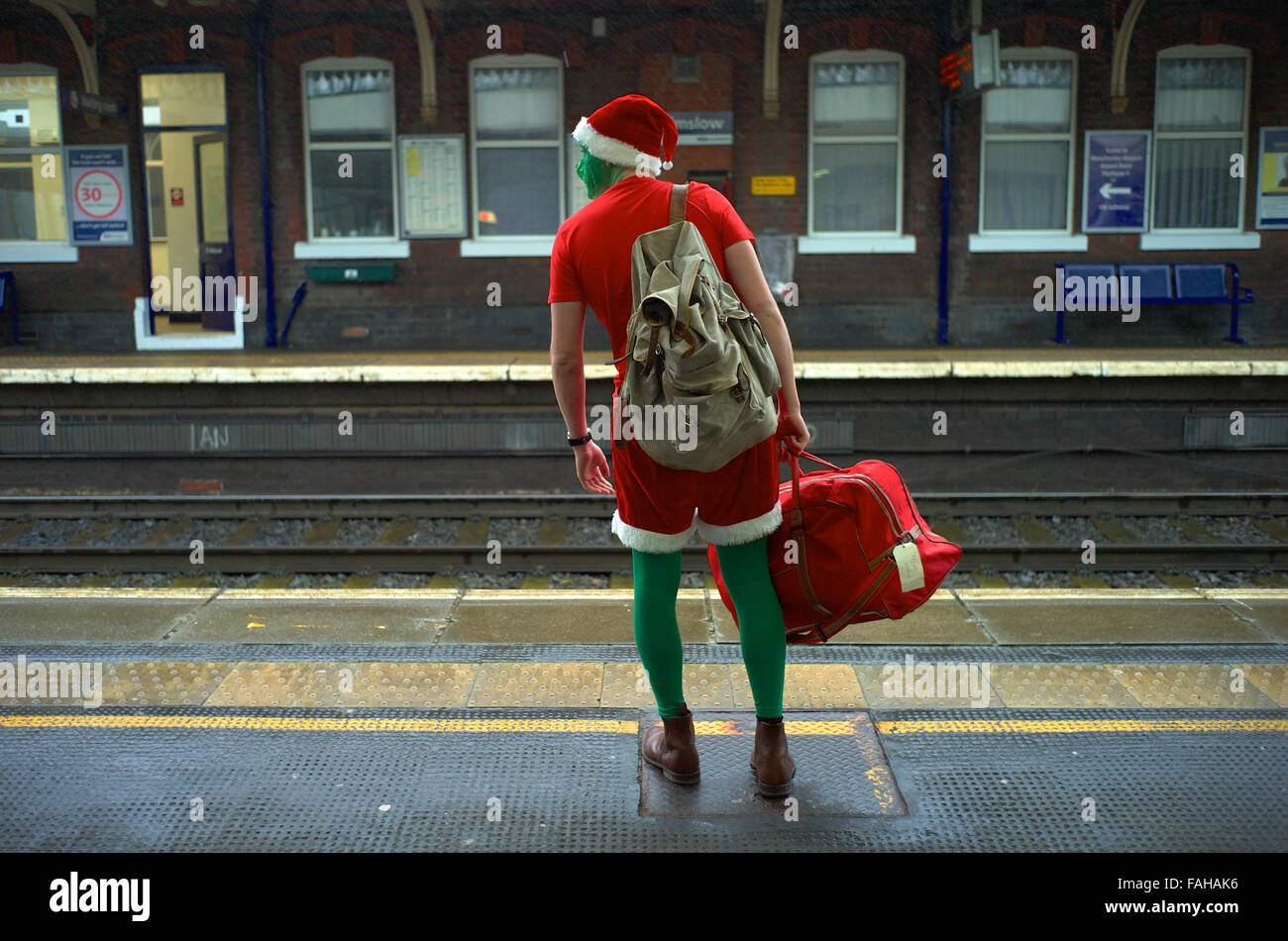 Festive traveler waits for his train on the platform. Stock Photo