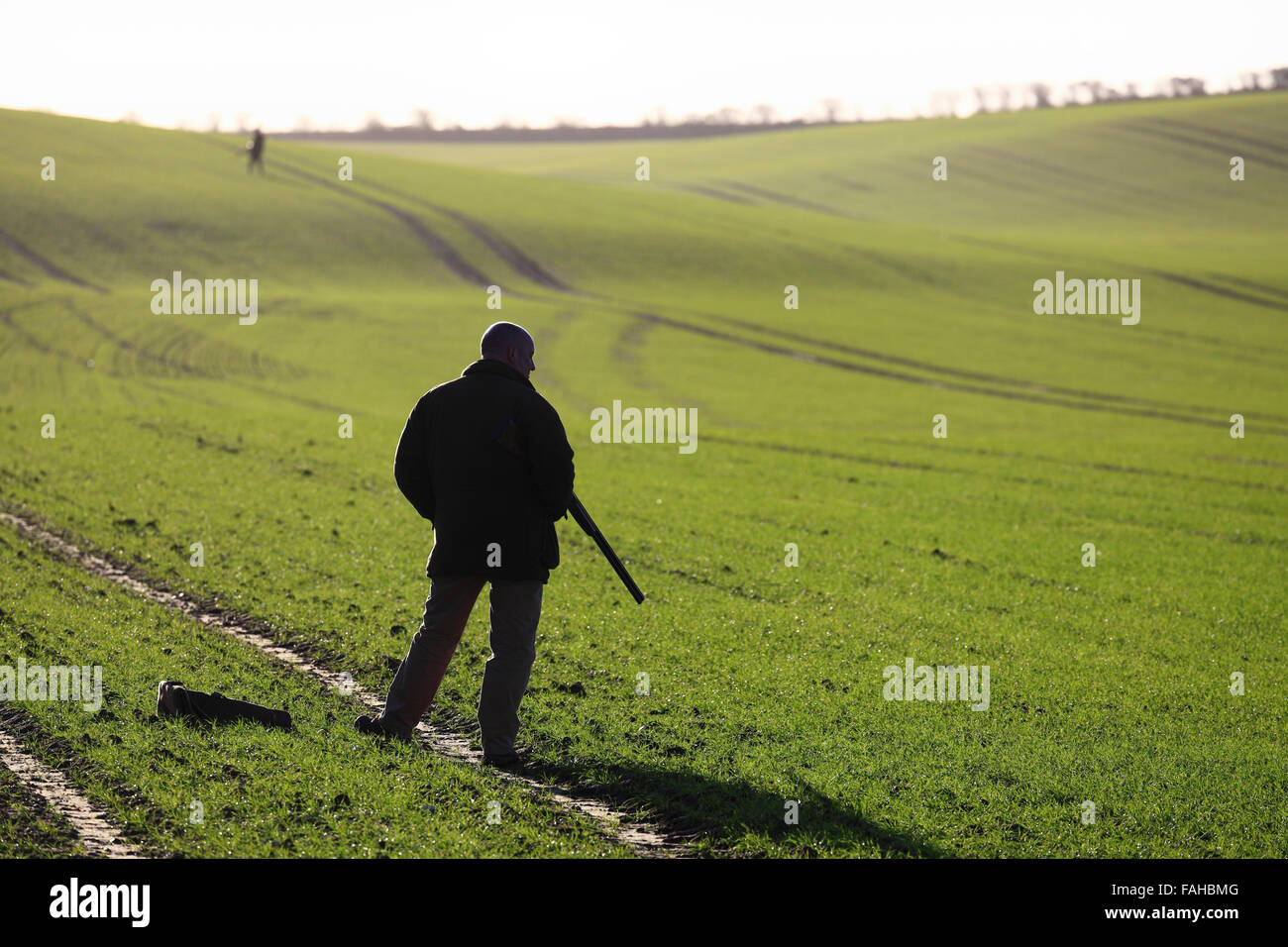 A man taking position during a winter shoot on farmland in North Norfolk. Stock Photo