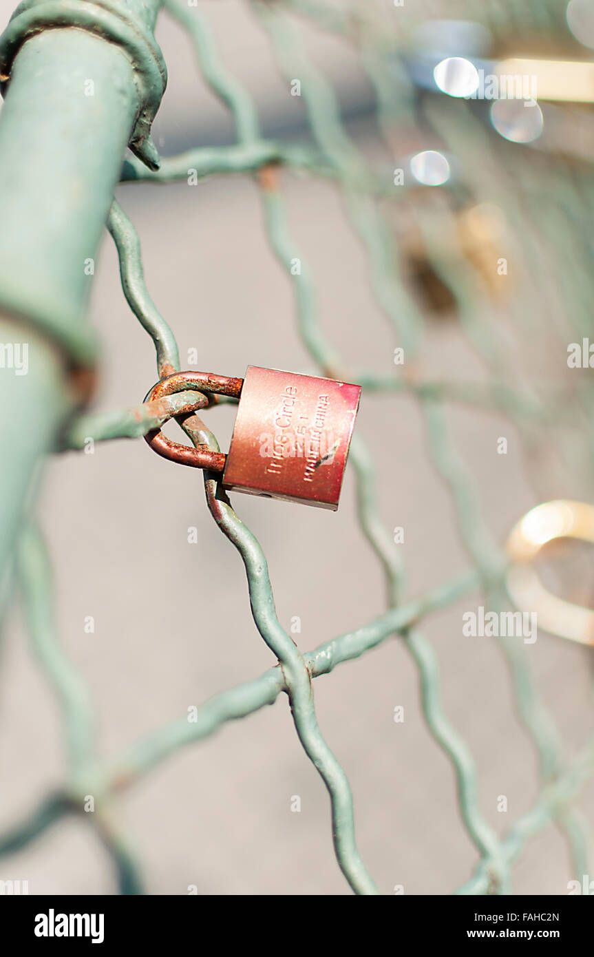 Close-up on lockers symbolizing everlasting love on a bridge fence Stock Photo