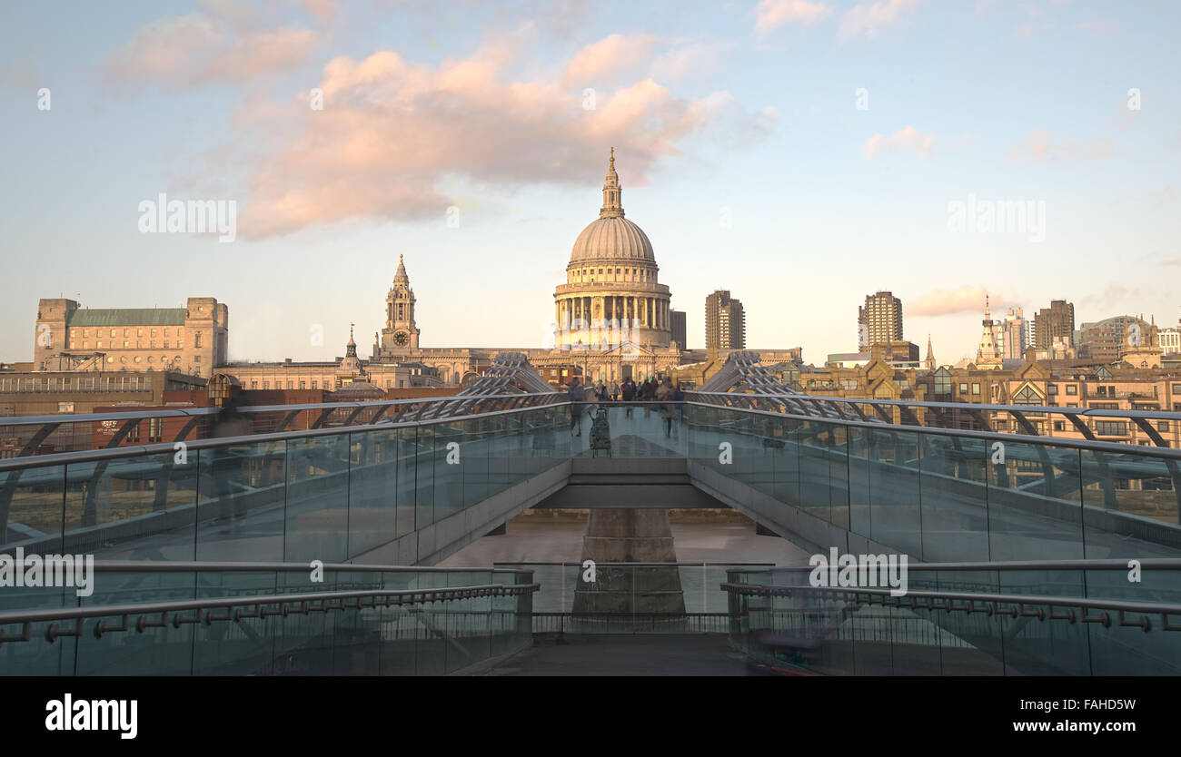 People walking at the  Millennium bridge , officially known as the London Millennium Footbridge with Saint Paul Cathedral. Stock Photo