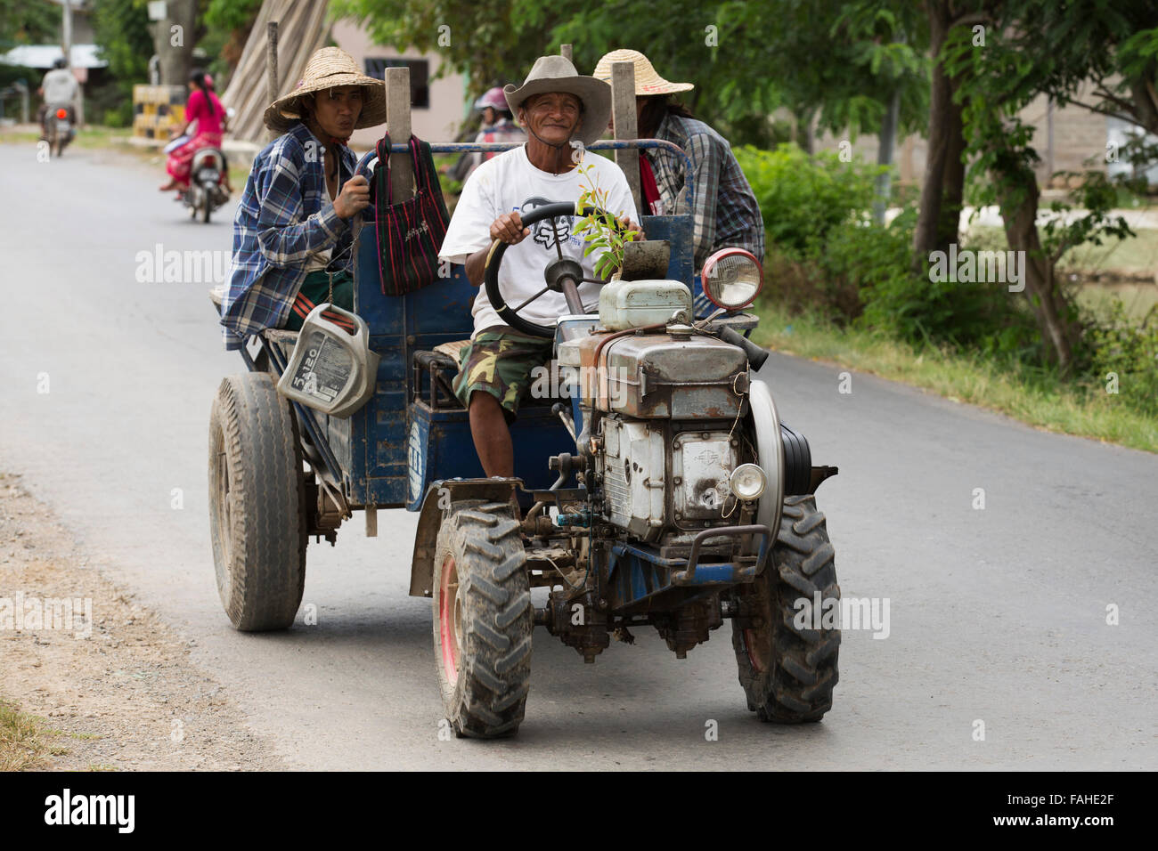 A farmer drives a tractor on a road near Heho, Myanmar (Burma). The low