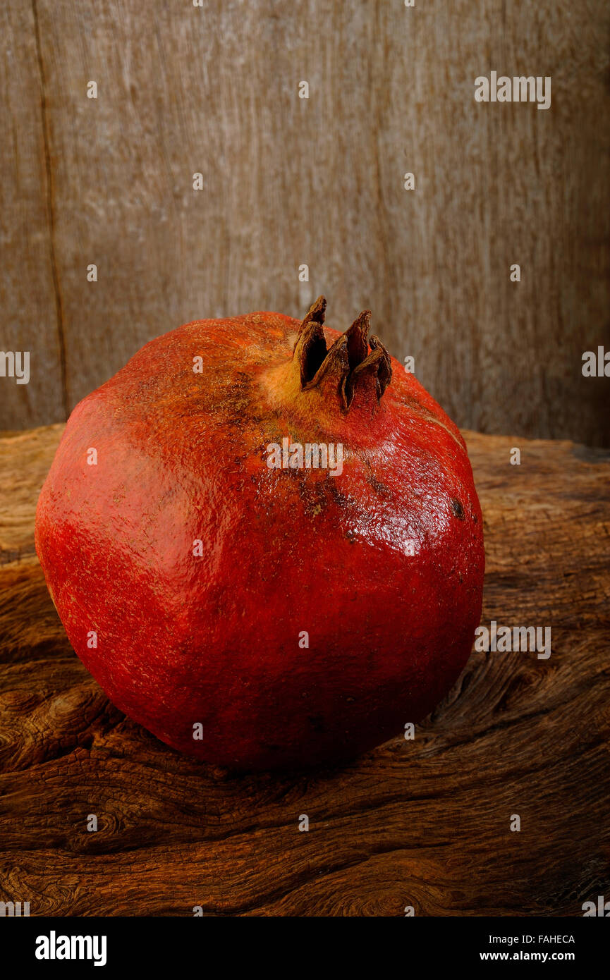 ripe pomegranate on wooden background Stock Photo