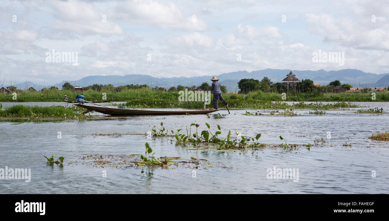 A fisherman from the Intha people rowing his boat on Inle Lake in Myanmar (Burma). Stock Photo