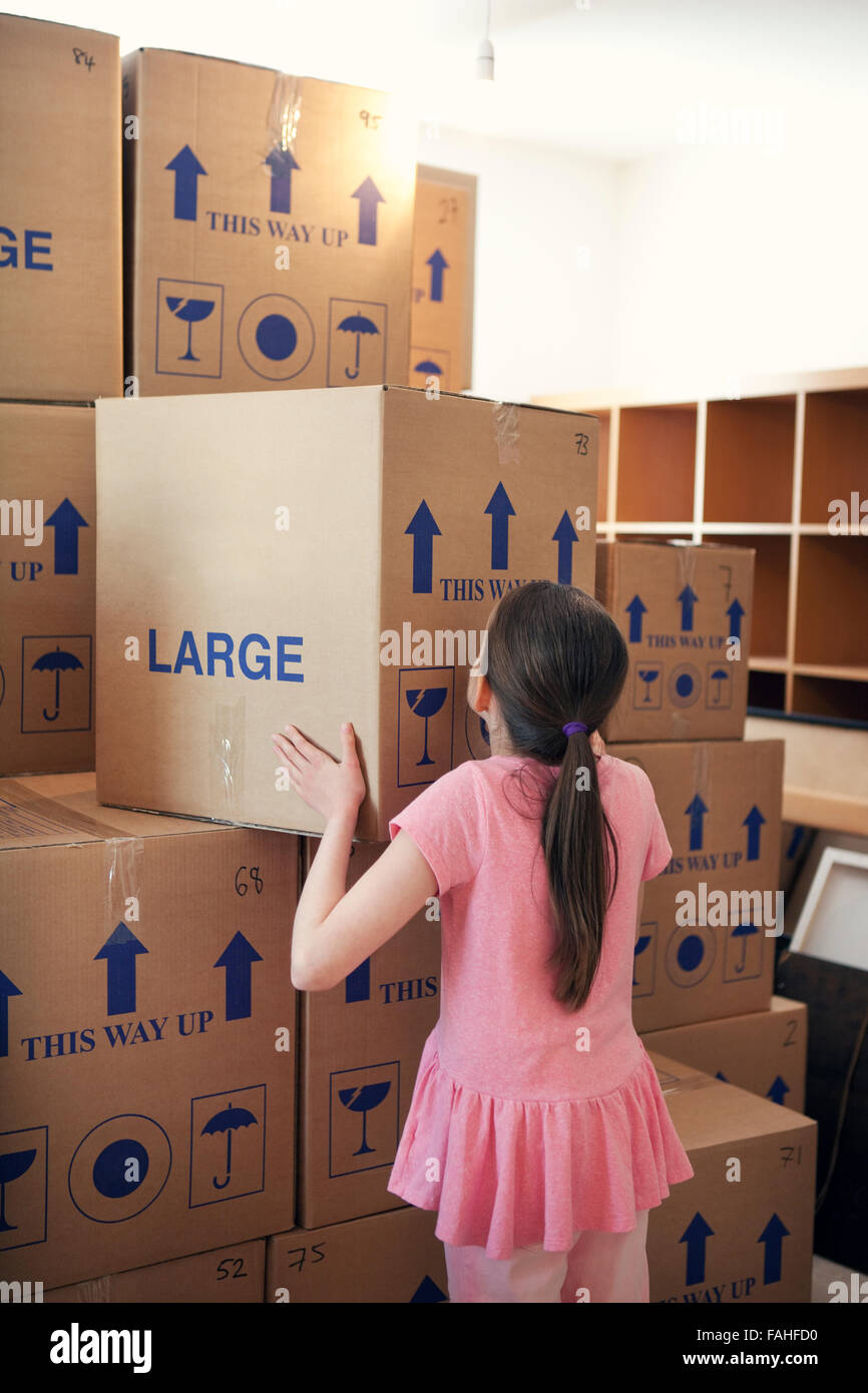Child stacking house moving boxes Stock Photo Alamy