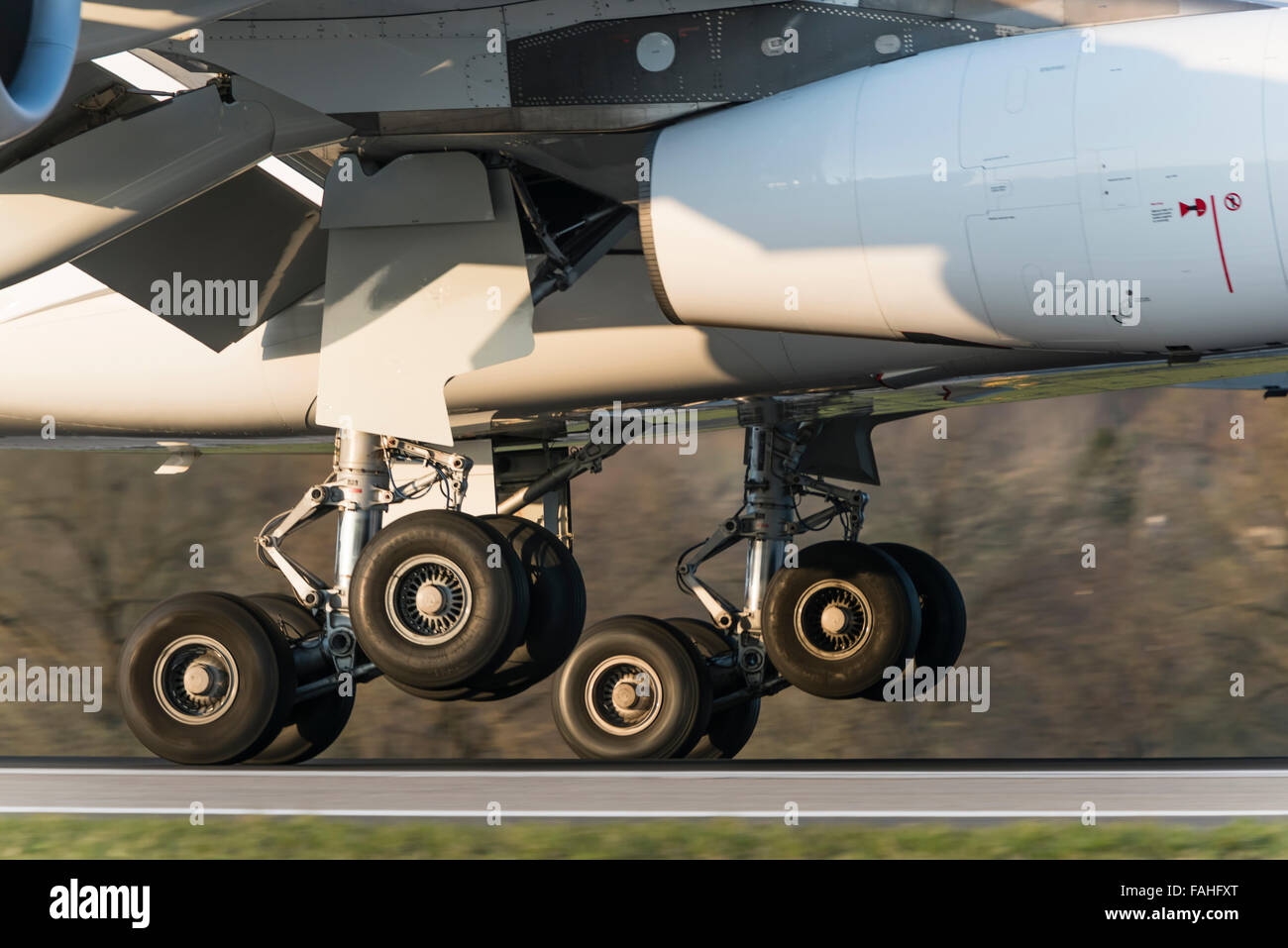 Tires of the main gear of an Airbus A340 passenger aircraft of Swiss International Air Lines are touching the ground during land Stock Photo