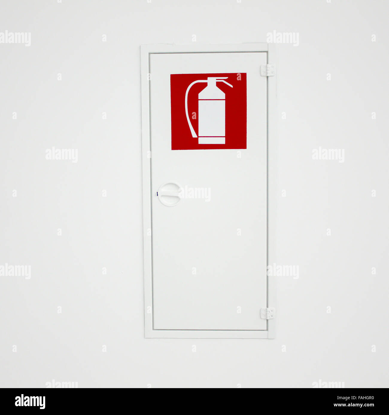 Fire extinguisher sign an box on a wall Stock Photo