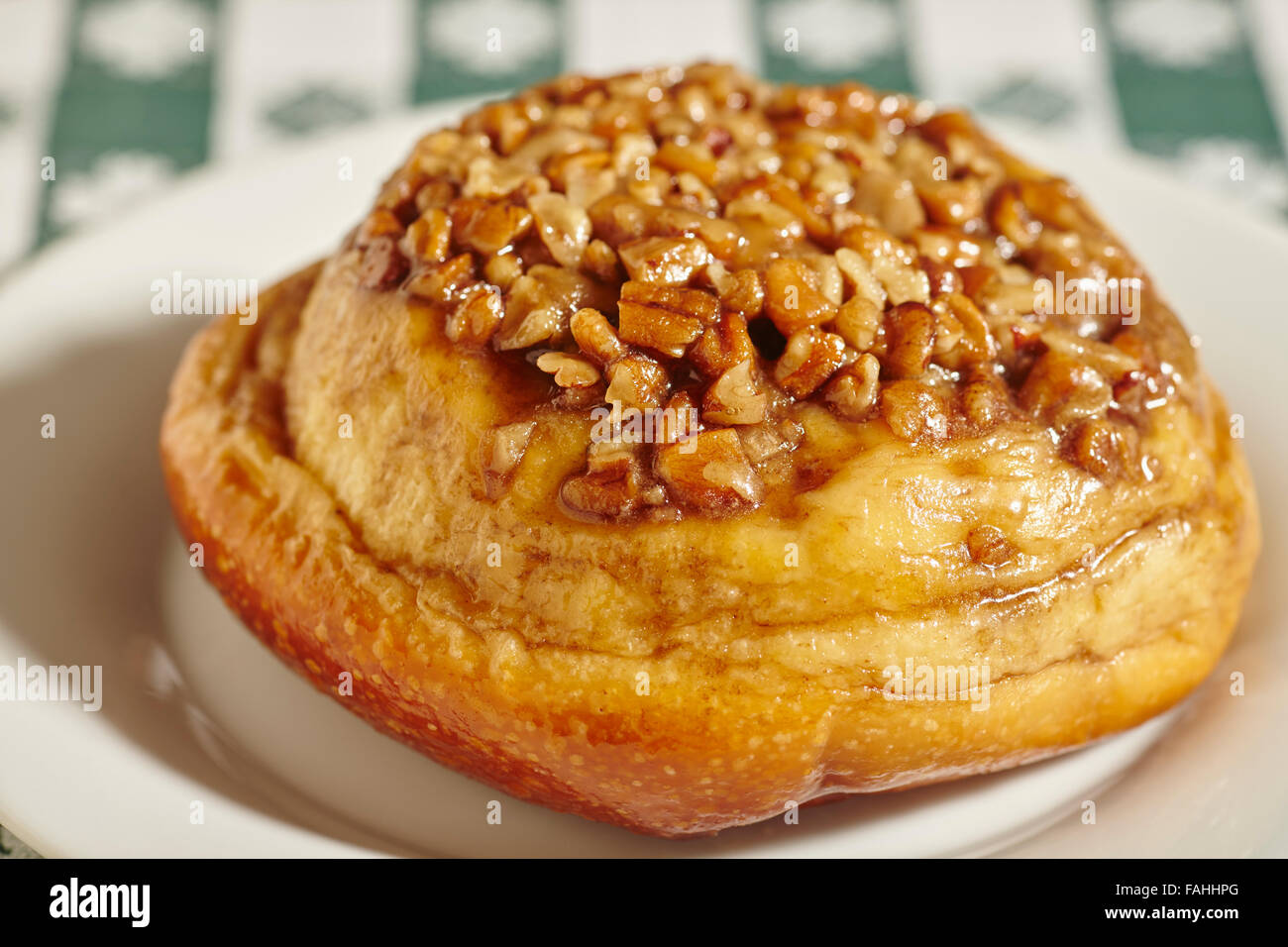 Sticky bun with nut topping Stock Photo