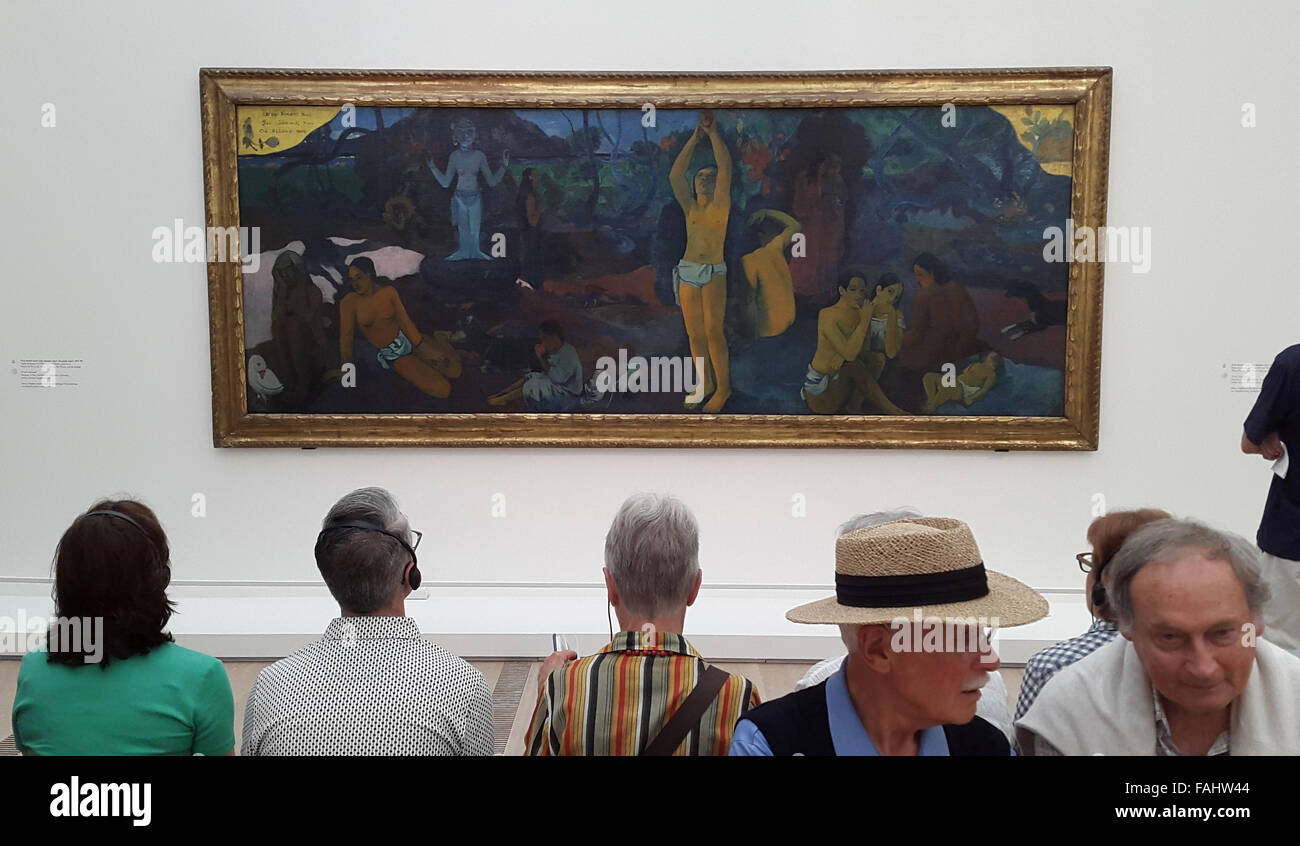 Visitors in front of the painting Where Do We Come From? What Are We? Where Are We Going? (1897) by French post-Impressionist artist Paul Gauguin at his retrospective exhibition in the Fondation Beyeler in Basel, Switzerland, on June 12, 2015. Stock Photo