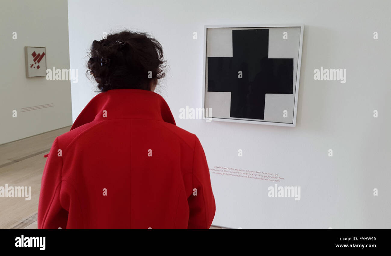 Visitor in front of the Suprematist painting Black Cross (1915) by Russian avant-garde artist Kazimir Malevich at the exhibition entitled In Search of 0,10 (Zero Ten) the Last Futurist Exhibition in the Fondation Beyeler in Basel, Switzerland, on November 28, 2015. The exhibition marks the 100th anniversary of the Black Square by Kazimir Malevich exhibited for the first time at the Last Futurist Exhibition 0,10 in December 1915 in Petrograd, Russian Empire. Stock Photo