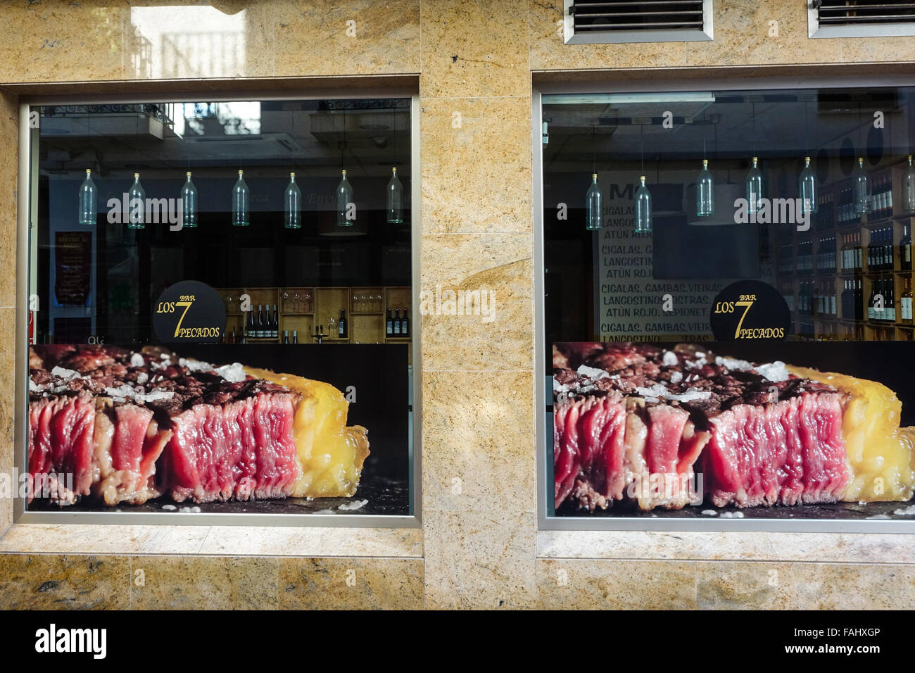 Benidorm Alicante Province Costa Blanca Spain. Old town restaurant window with fatty rare steak image in windows Stock Photo