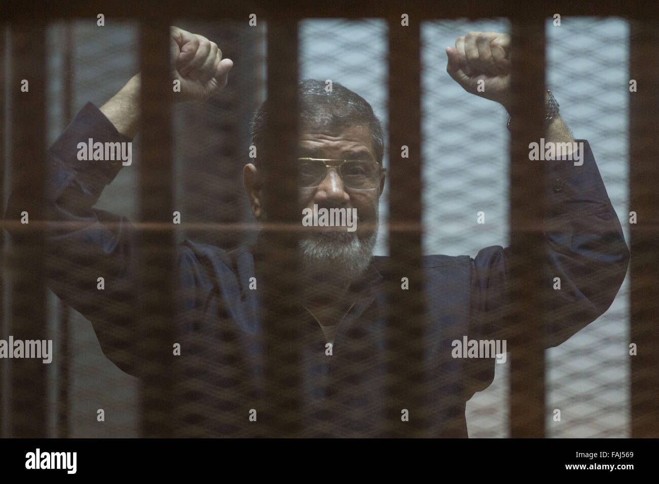 Beijing, Egypt. 16th June, 2015. Egypt's ousted President Mohamed Morsi gestures behind the defendants' cage at a court in Cairo, Egypt, on June 16, 2015. © Pan Chaoyue/Xinhua/Alamy Live News Stock Photo
